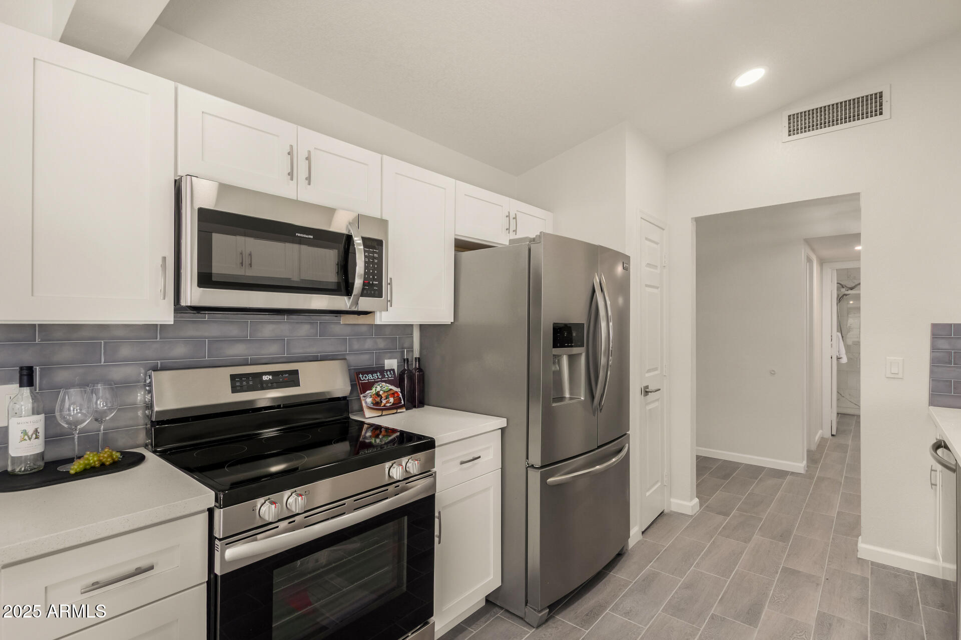 4214 East Agave Road Phoenix, AZ 85044 - Photo 7 of 67 a kitchen with a refrigerator stove and microwave