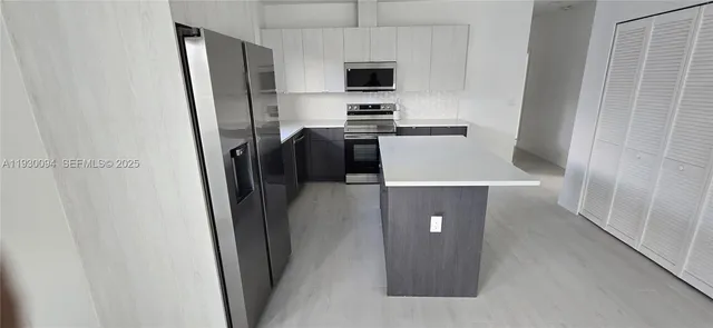 a room with a refrigerator and a stove