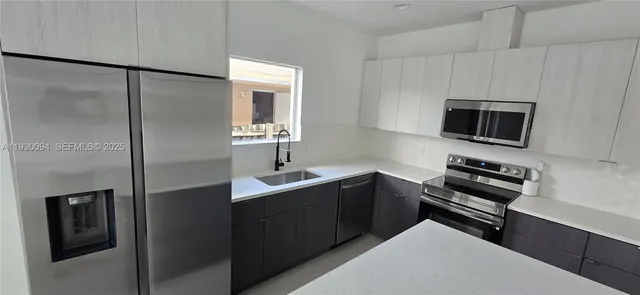 a kitchen with a refrigerator and a sink