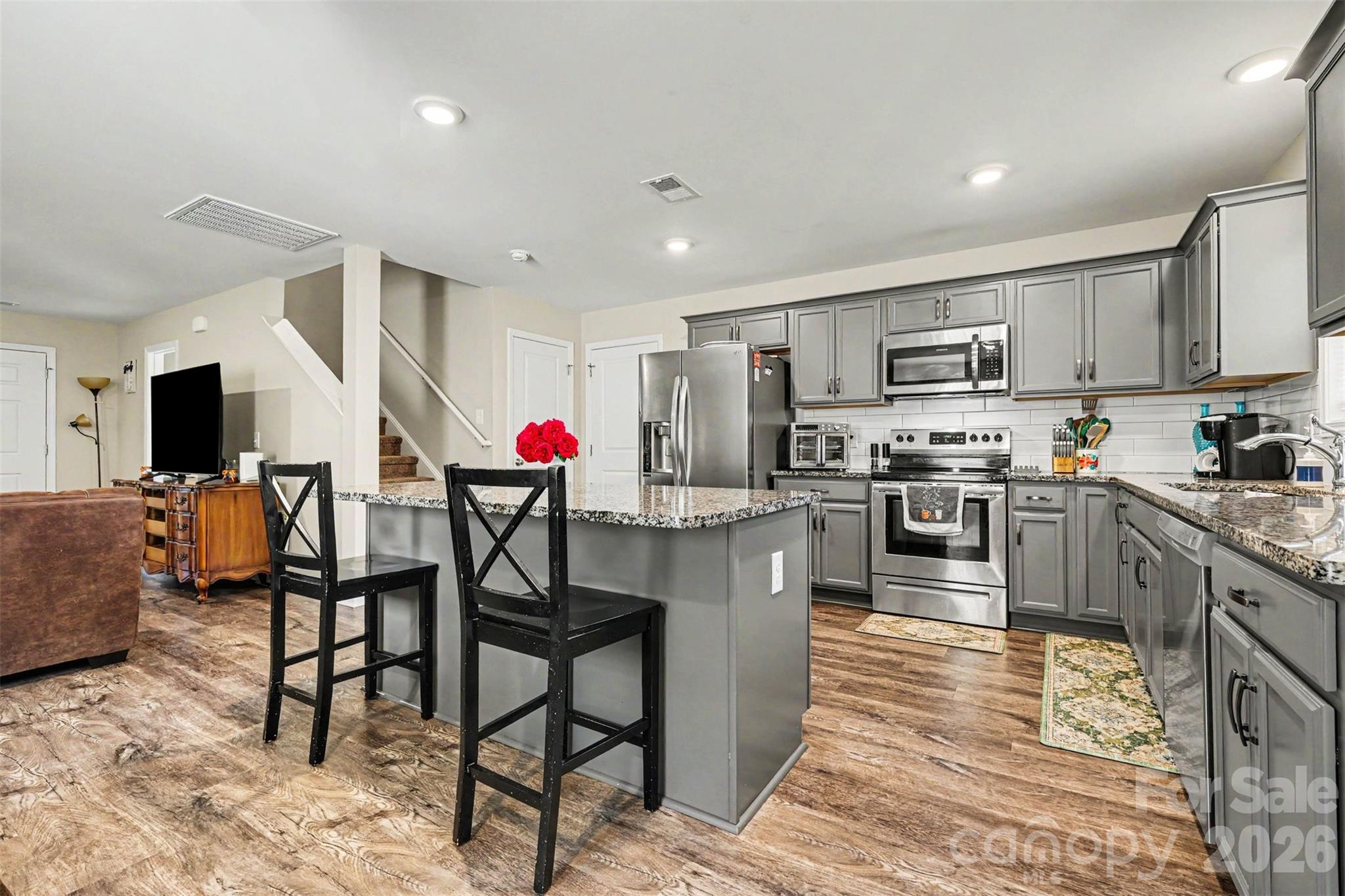 3401 State Rd S-46-76 Sharon, SC 29742 - Photo 12 of 44 a kitchen with stainless steel appliances granite countertop a stove top oven a sink dishwasher and a dining table with wooden cabinet