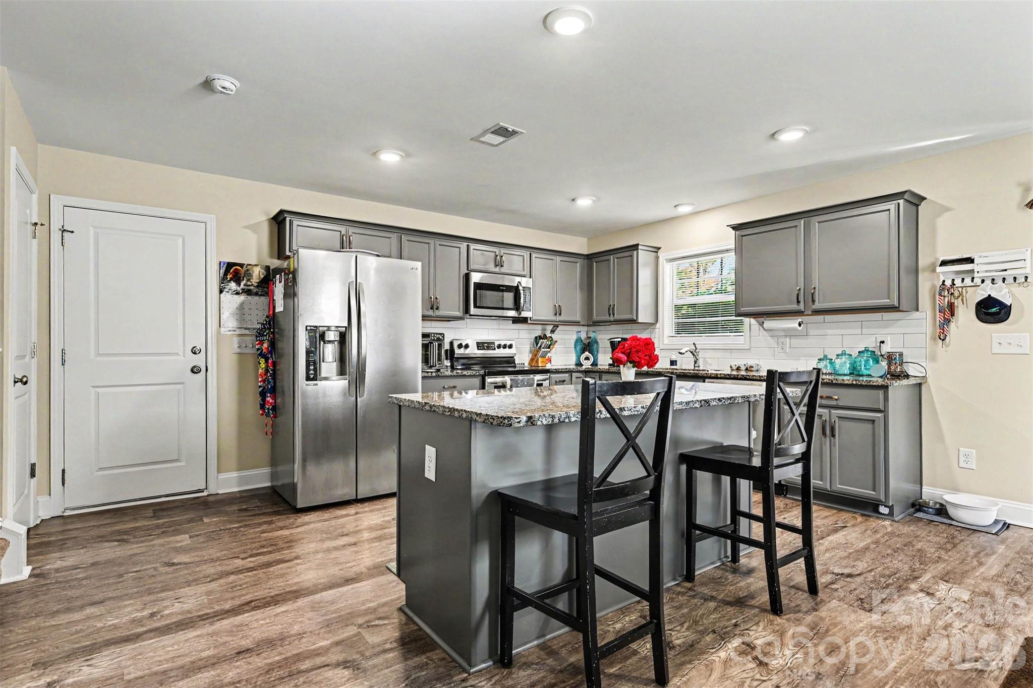 3401 State Rd S-46-76 Sharon, SC 29742 - Photo 13 of 44 a kitchen with refrigerator a sink and chairs