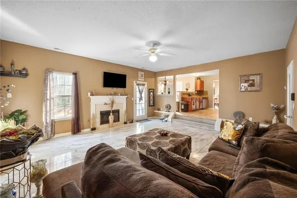a living room with furniture fireplace and a flat screen tv