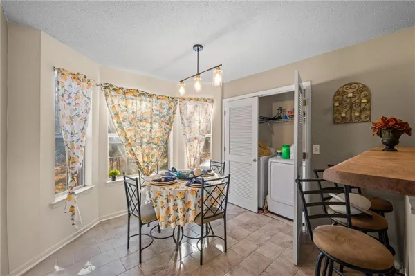 a dining room with furniture and window
