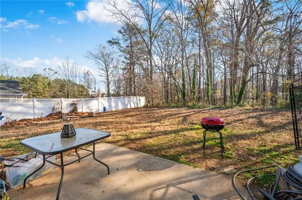 a backyard of a house with table and chairs