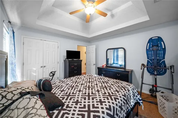 a bedroom with a bed and dresser with mirror