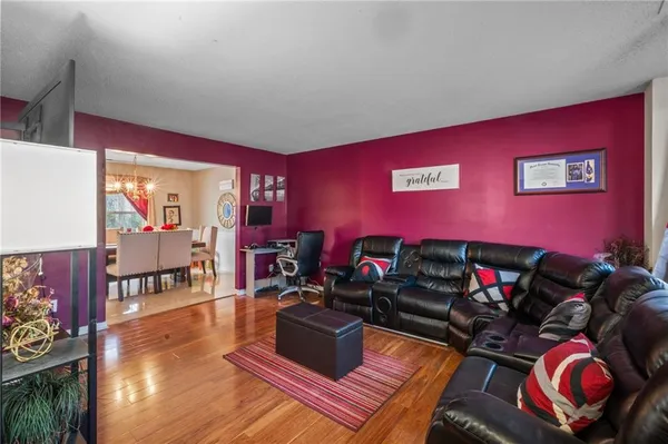 a living room with furniture and a floor to ceiling window