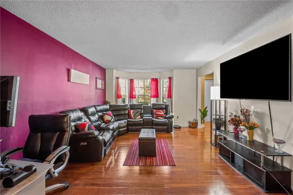 a living room with furniture and a flat screen tv