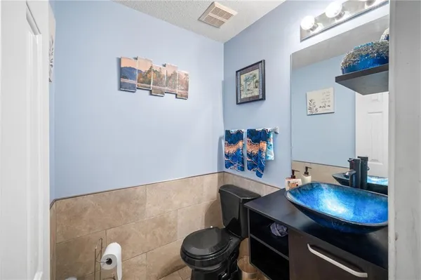a bathroom with a sink a toilet and mirror