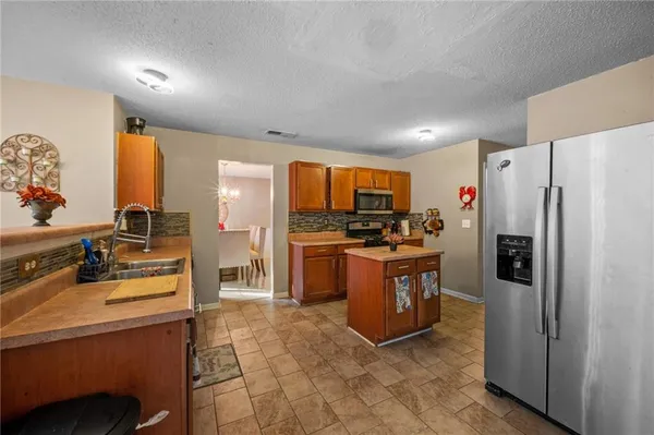 a kitchen with stainless steel appliances a refrigerator stove and sink