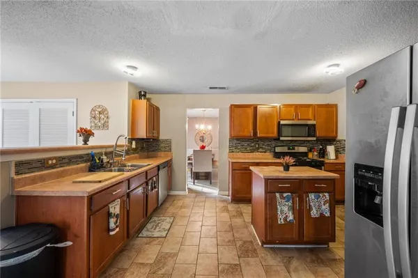 a large kitchen with stainless steel appliances granite countertop a large stove top oven