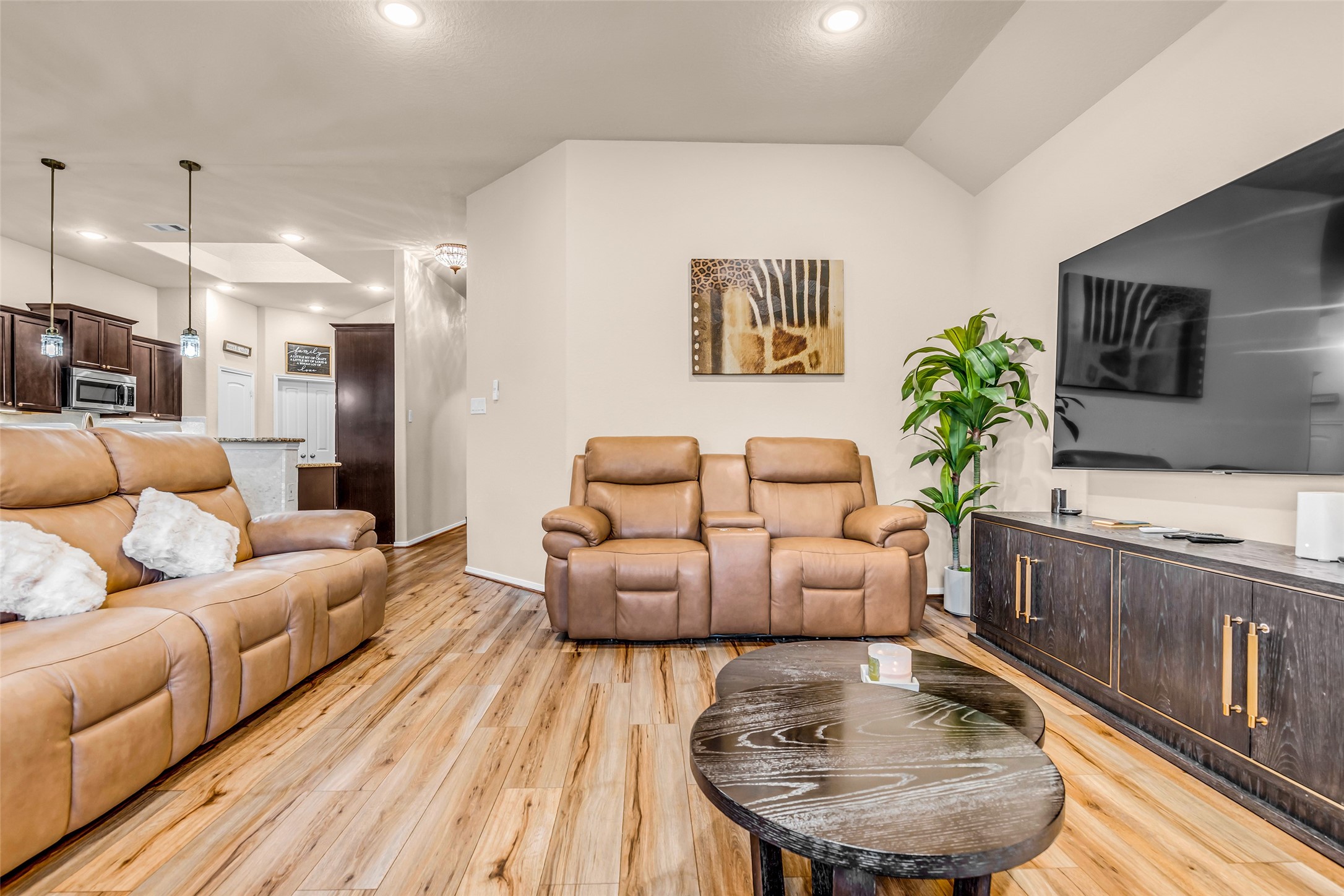 22907 Banff Brook Way Tomball, TX 77375 - Photo 6 of 26 An additional view of the living room with the kitchen visible in the background, highlighting the open layout and easy flow between spaces.