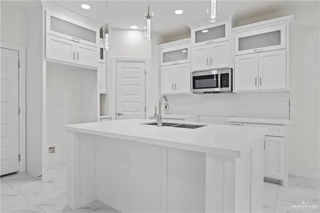 a kitchen with stainless steel appliances a sink and a microwave