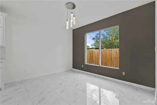 wooden floor in an empty room with a kitchen
