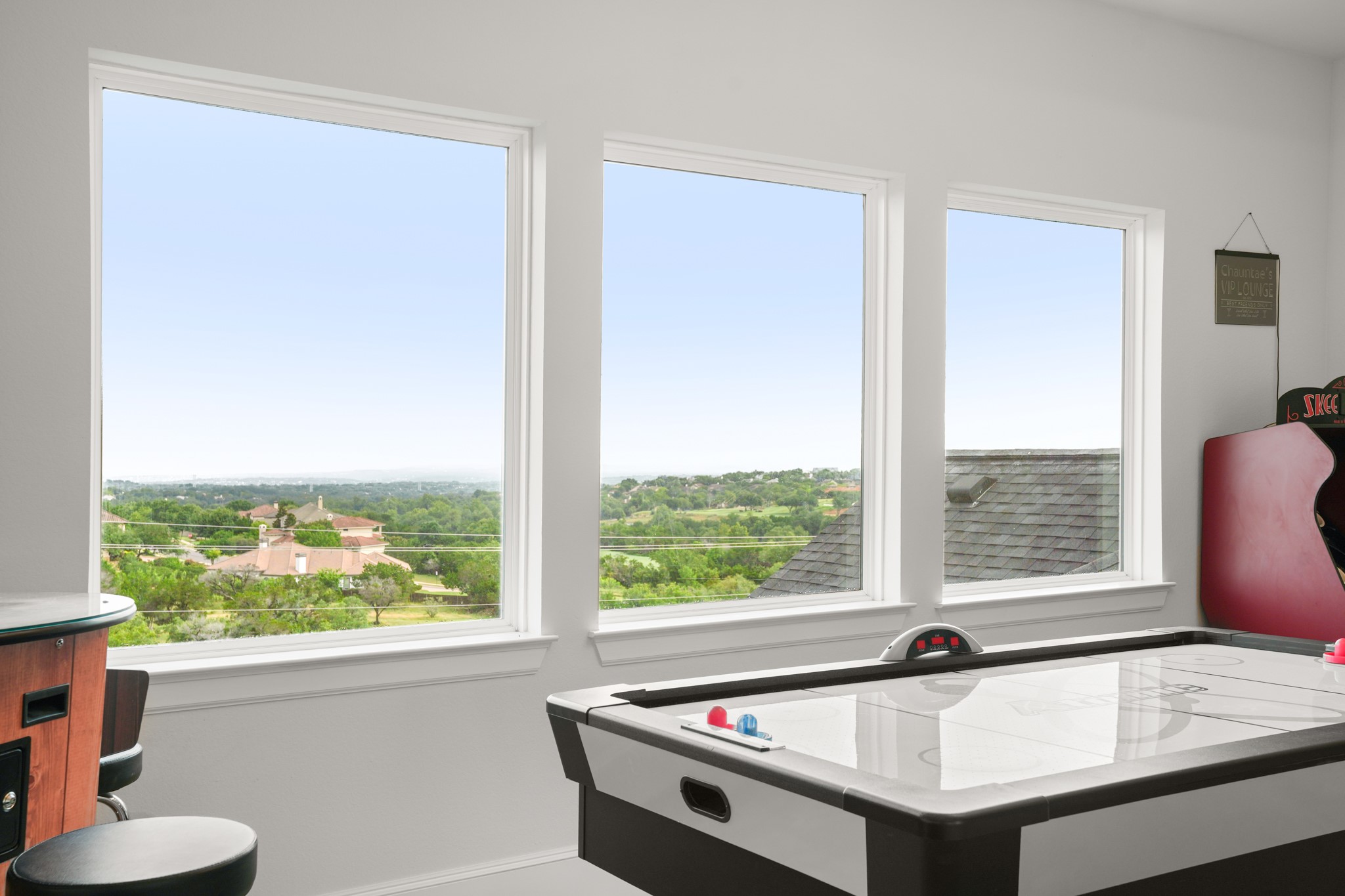 104 Lodestone Cove Austin, TX 78738 - Photo 26 of 40 A vibrant game room offers panoramic views of the verdant landscape through generous windows.