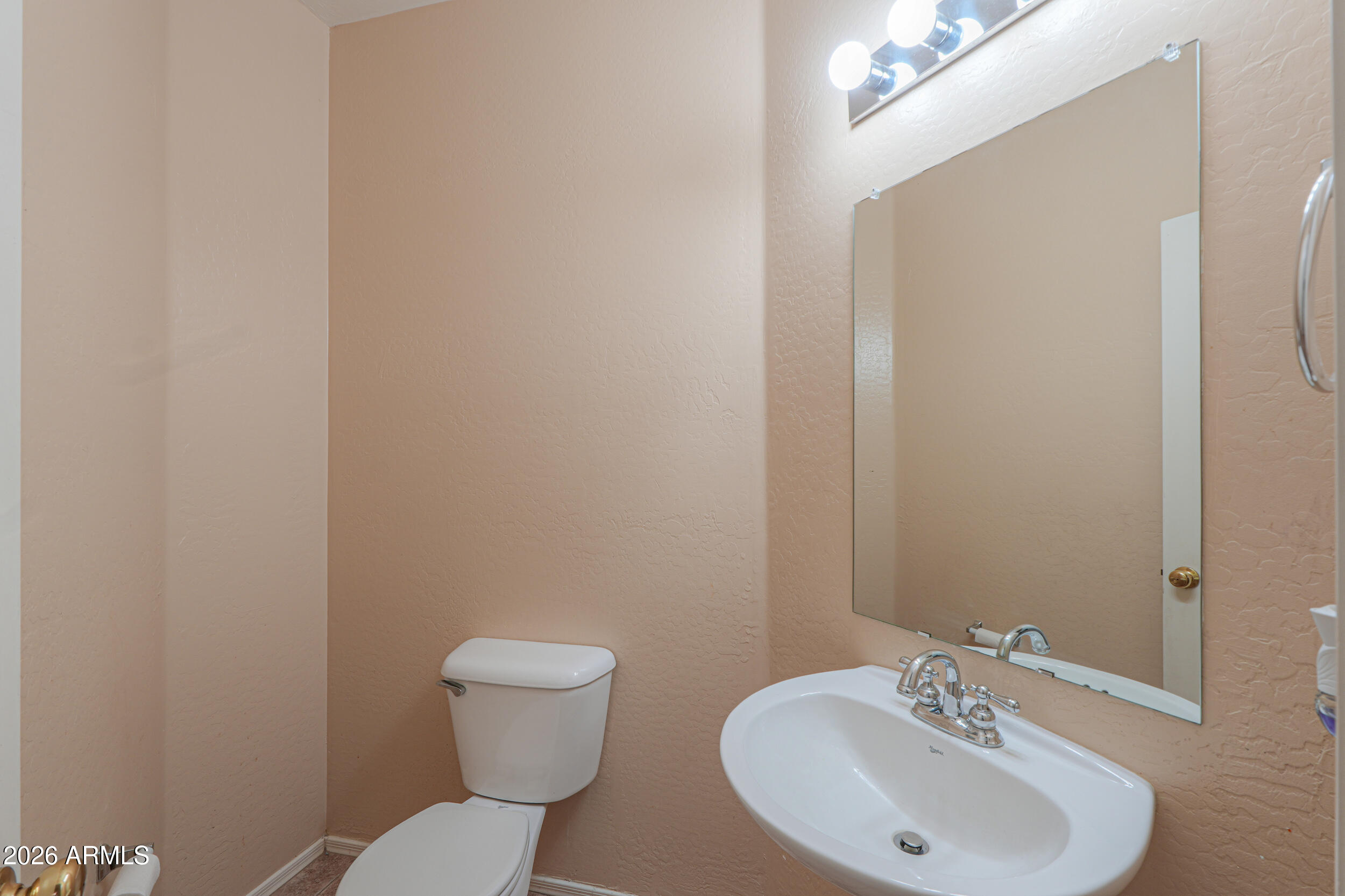 46136 West Sonny Road Maricopa, AZ 85139 - Photo 15 of 81 a bathroom with a toilet a sink and mirror