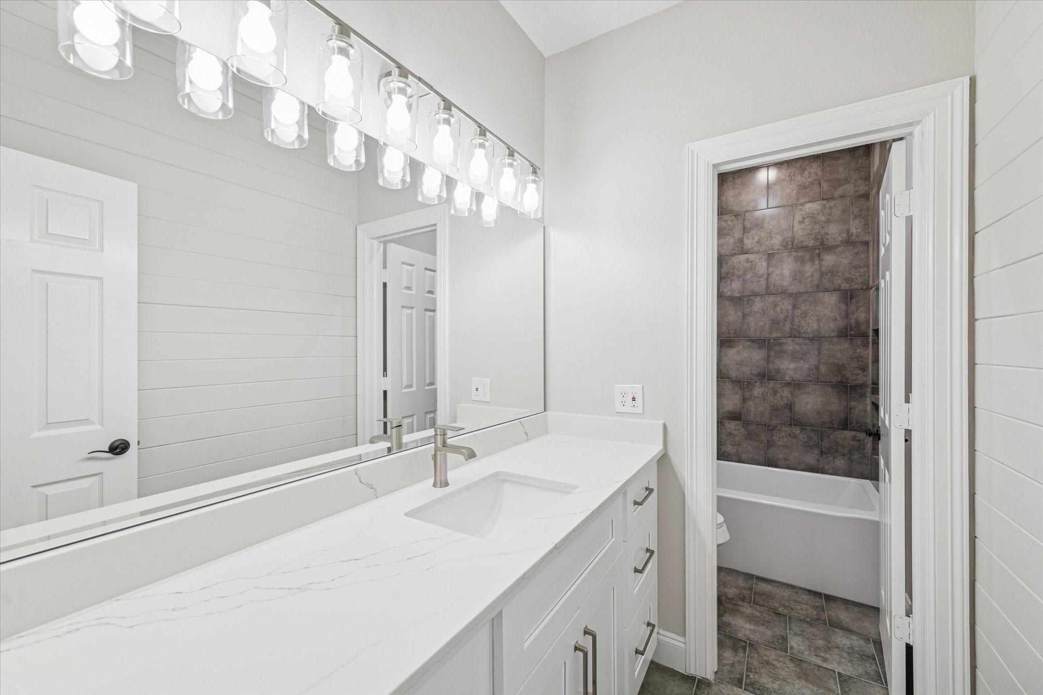 5437 Edgewater Court Willis, TX 77318 - Photo 23 of 29 a bathroom with a double vanity sink mirror and shower