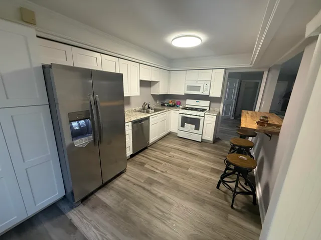 a kitchen with a refrigerator a stove top oven a sink and dishwasher