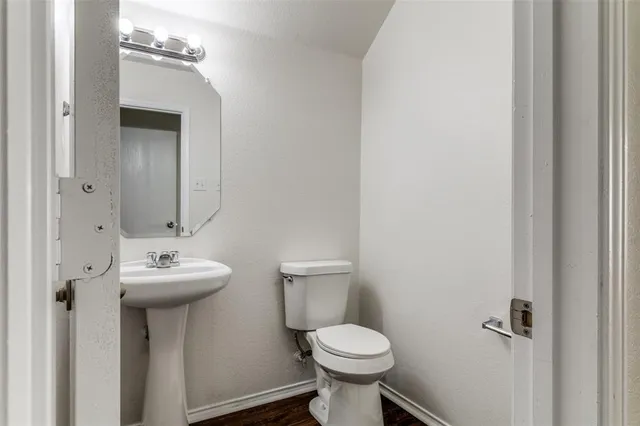 a bathroom with a sink mirror and toilet