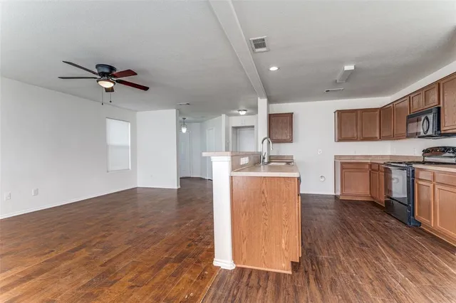 a view of kitchen with sink microwave and stove