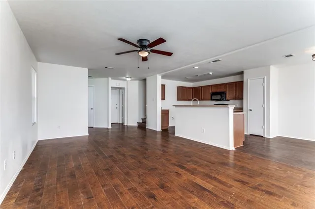 a view of a kitchen with a microwave and a stove top oven