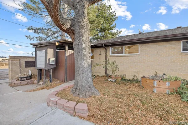 a backyard of a house with table and chairs