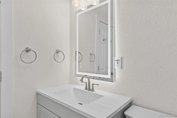 a bathroom with a sink vanity and a mirror