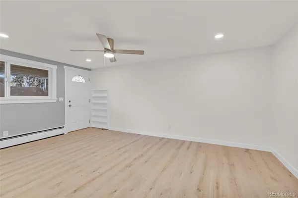 wooden floor in an empty room with a window