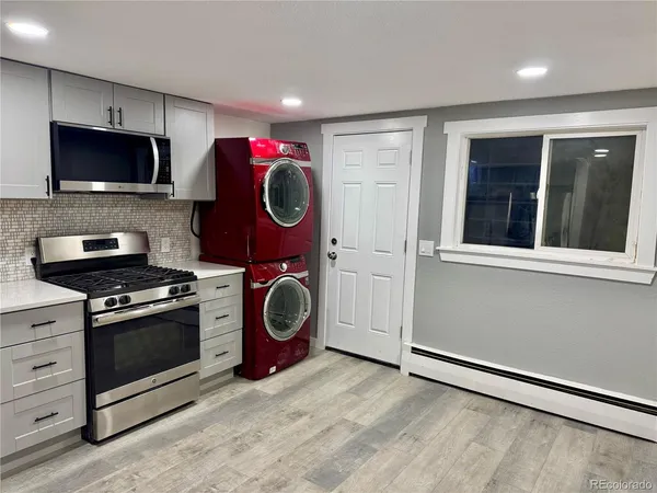 a kitchen with a stove a microwave and sink