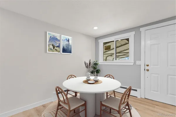 a view of a dining room with furniture and wooden floor