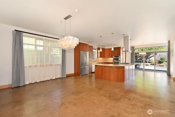 a large kitchen with a lot of counter space and a chandelier