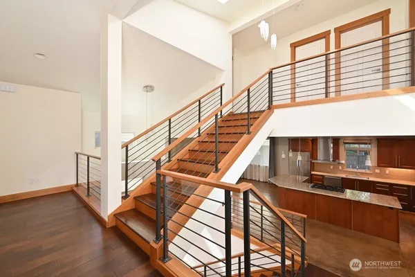 a view of entryway and hall with wooden floor