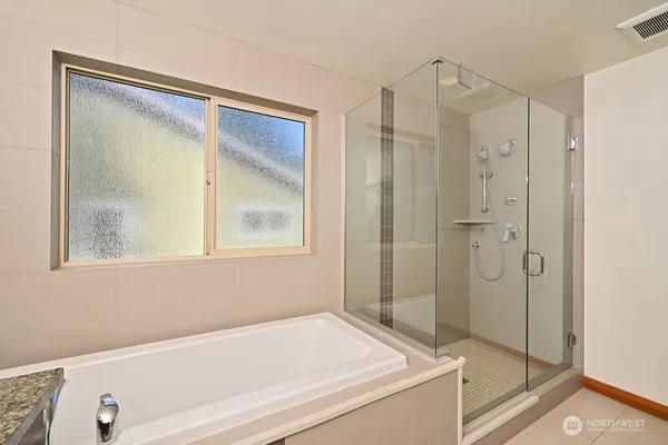 a bathroom with a tub and a shower