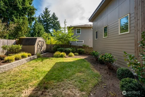 a view of a backyard with plants and a patio