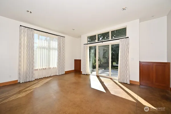 a view of an empty room with glass door
