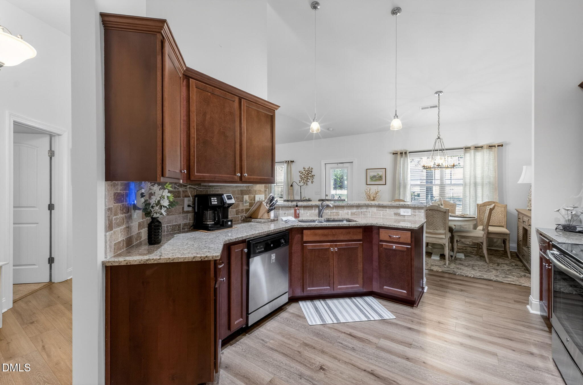 20 Deep Clay Circle Angier, NC 27501 - Photo 21 of 54 a kitchen with stainless steel appliances granite countertop wooden cabinets a stove top oven a sink and dishwasher with wooden floor