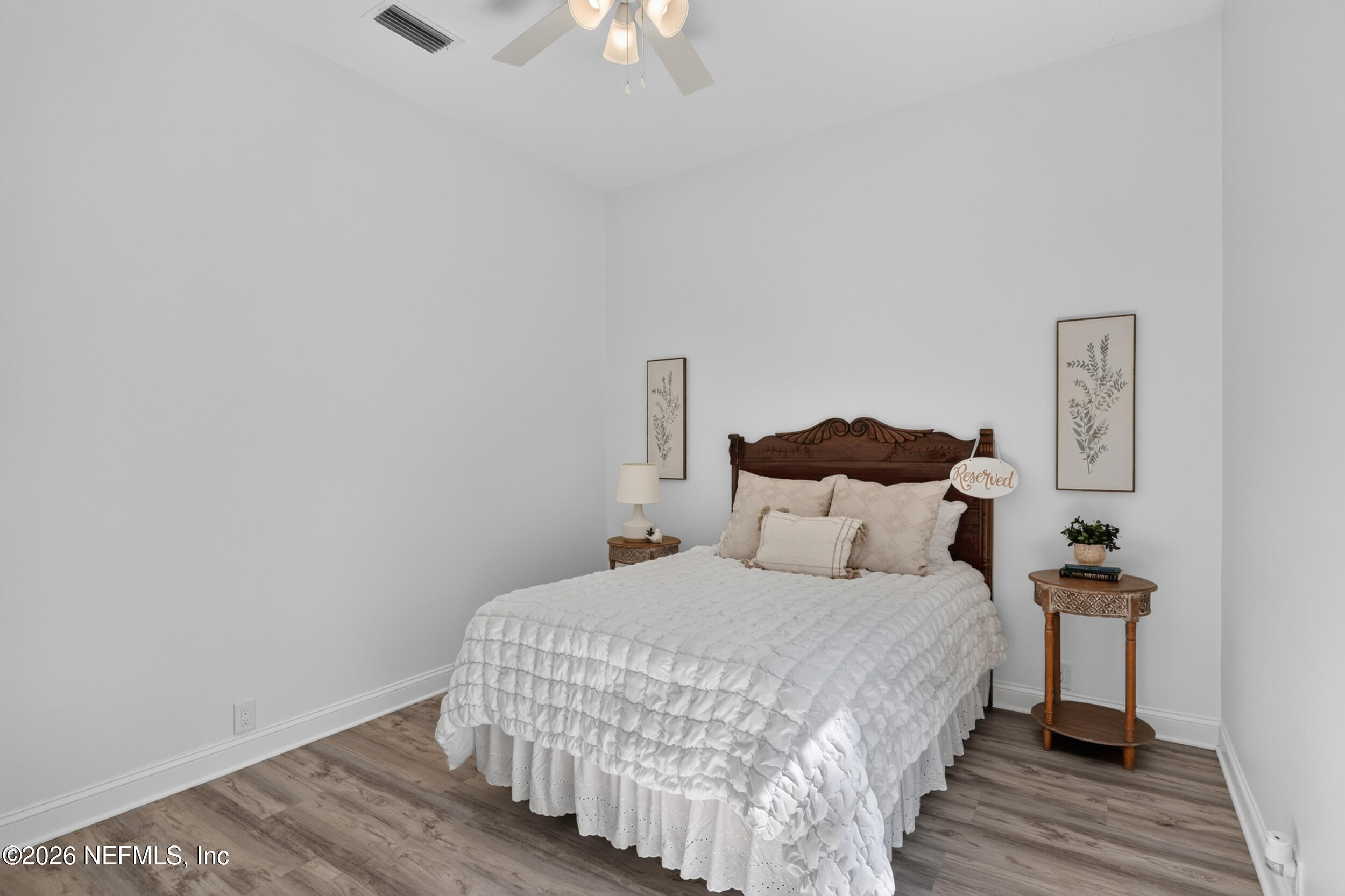 3090 Monument Bay Road St. Augustine, FL 32092 - Photo 33 of 56 a bedroom with a bed and wooden floor