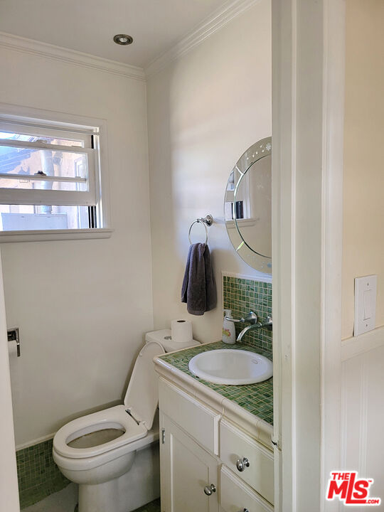3913 Mohawk Street Pasadena, CA 91107 - Photo 9 of 14 a bathroom with a granite countertop toilet sink and mirror