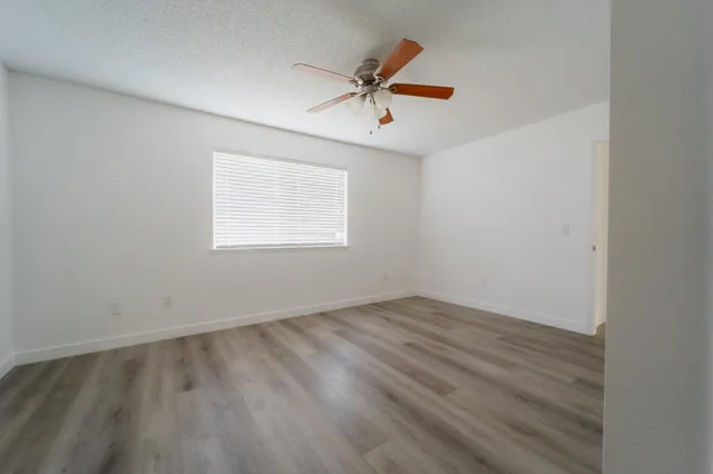 wooden floor in an empty room with a window