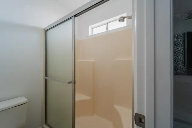 a bathroom with a shower and a toilet