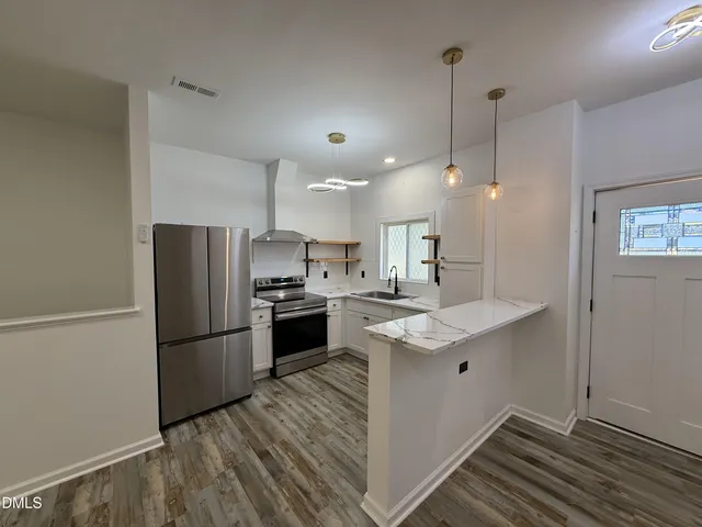 a view of a hallway with wooden floor