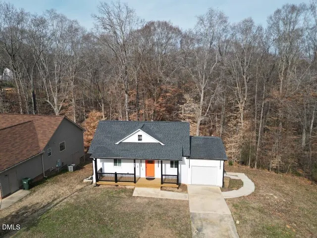 a aerial view of a house with a yard