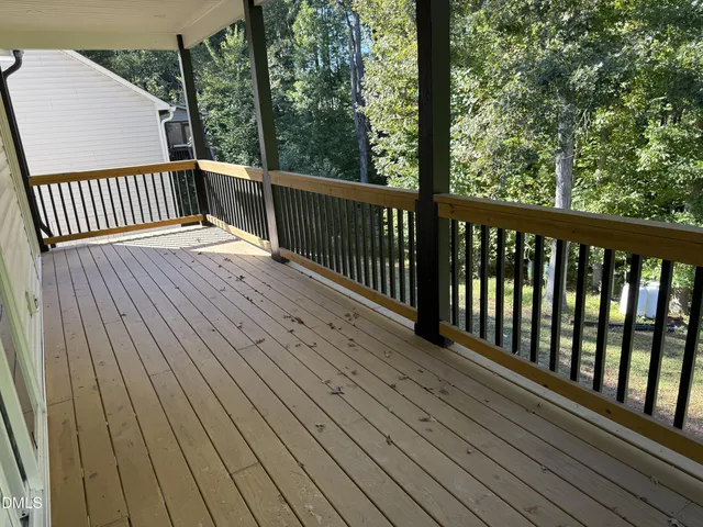 a view of balcony with wooden floor