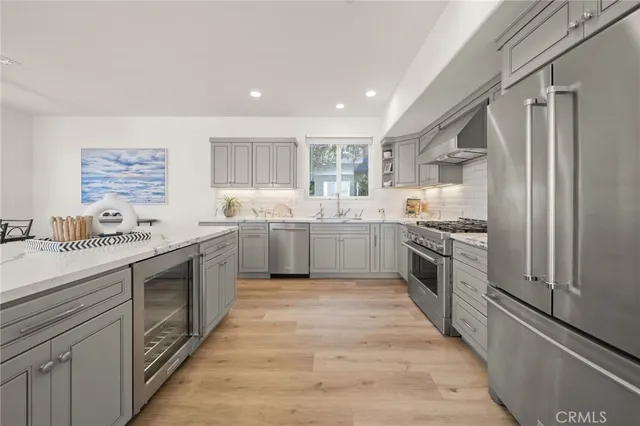 a kitchen with a sink and wooden floor