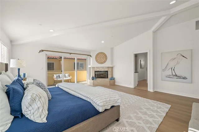 a spacious bedroom with a bed couch and window