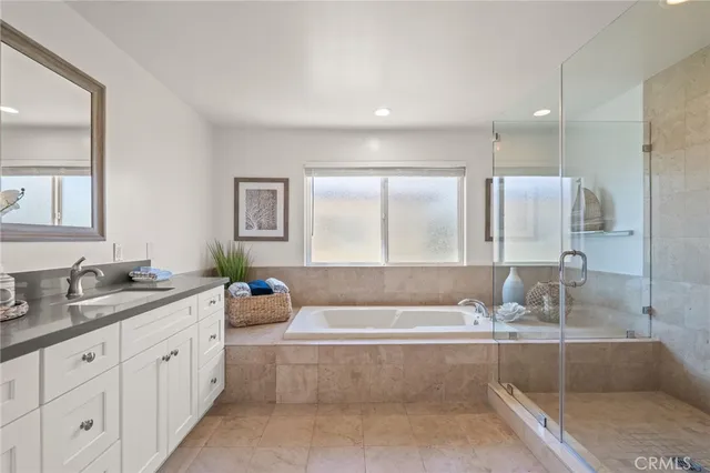 a bedroom with a large bed and a potted plant