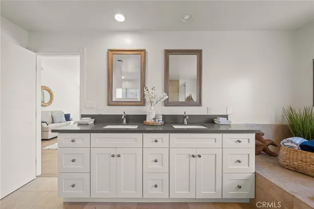 a bathroom with a double vanity sink toilet and shower