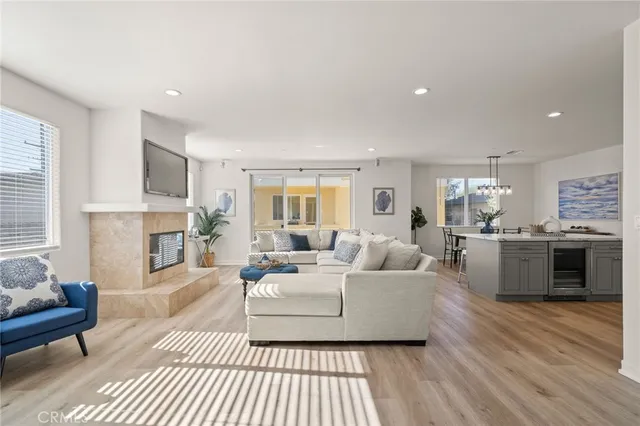 a living room with furniture fireplace and a window