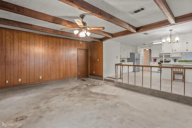 a view of a livingroom with furniture and a window