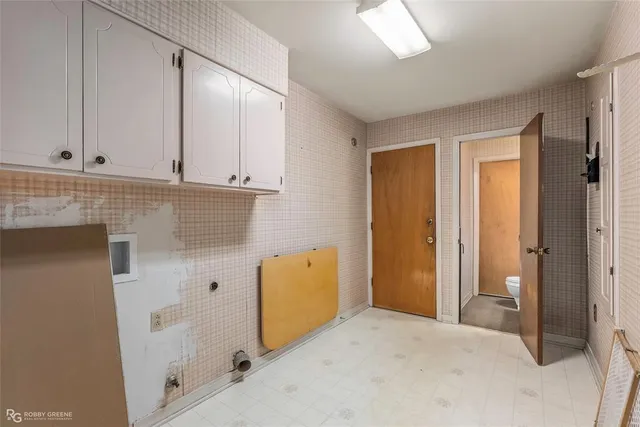 a view of a storage & utility room with closet dryer
