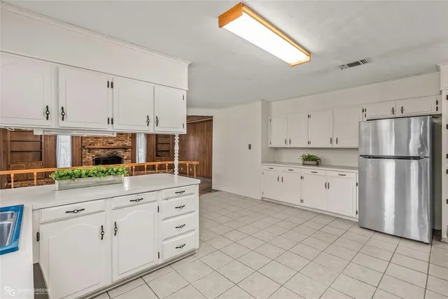 a kitchen with white cabinets and white appliances